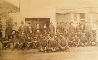 ANTIQUE WWI PHOTO OF A LARGE GROUP of SOLDIERS W/ BUGLE RAILROAD POSTER IN BACK 2