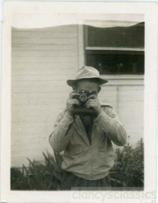 1939 Man Holds Up A Camera Duelling Cameras Takes Snapshot