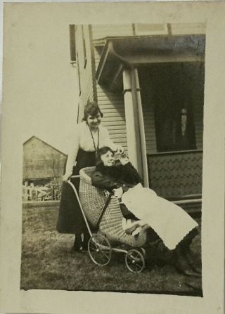 Vintage Old 1920s Funny Photo Of Girl In Wicker Baby Stroller Being Fed A Bottle