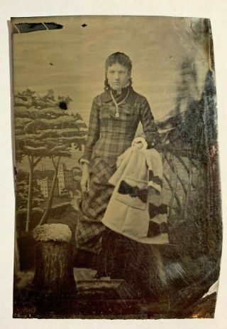 Tintype Photograph,  Young Woman In Plaid Dress With Her Coat Hanging Next To Her