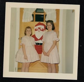 Vintage Photograph Two Girls In Matching Outfits Standing By Santa Decoration