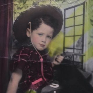 Vintage photograph color tinted,  little girl dressed as a cowboy 2