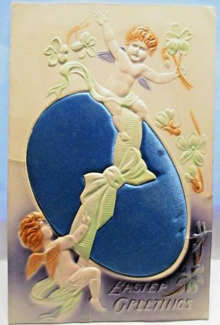 1910 Highly Embossed Postcard Easter Greetings,  Angels On Large Blue Satin Egg