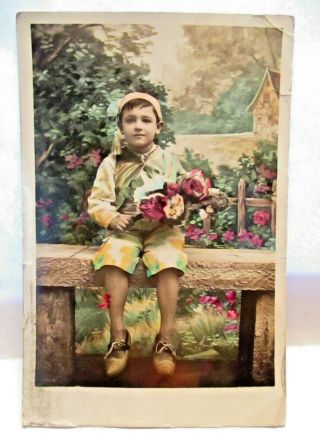 1910 Real Photo Postcard Boy In Native Costume On Wall,  Flowers,  Hand Colored