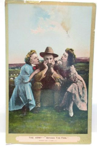 1909 Risque Postcard The Army " Between Two Fires " Soldier Between 2 Girls Kiss