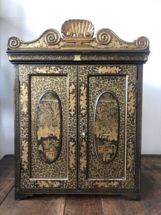 A Chinese Export Black Lacquered And Gilt Decorated Collector’s Cabinet