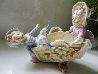 Antique Bisque Figurine Of 2 Children Playing On A Basket Seesaw - C1980 