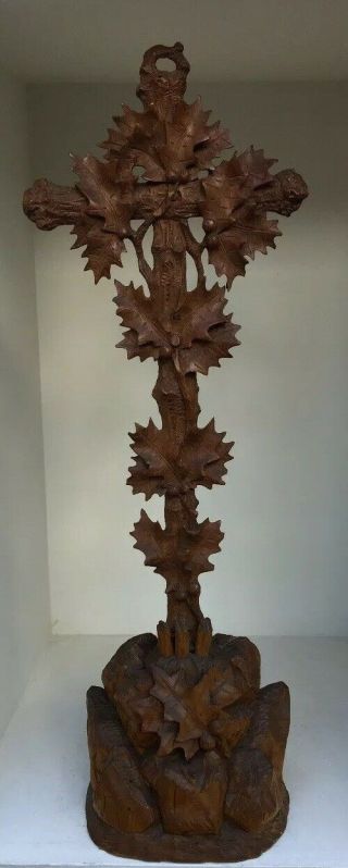 Black Forest Carving Of A Cross Overgrown With Holly