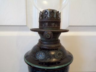 A Victorian black glazed pottery oil lamp drop in font order very ornate 3