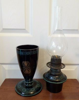 A Victorian black glazed pottery oil lamp drop in font order very ornate 6