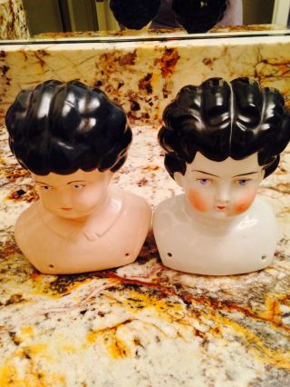TWO DOLL HEADS,  INCLUDING ANTIQUE PORCELAIN DOLL HEAD Embossed 