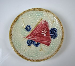 Antique English Majolica Butter Pat With Red Fan Light Blue Background