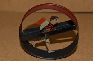 Antique Tinplate Walking Boy With Red & White Flag In Hoop 1920 