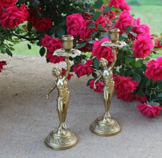A 19th Century French Gilt Bronze Candle Holders Featuring A Young Man