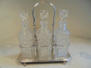 Antique Silver Plated Tantalus,  3 Cut Glass Decanter Set