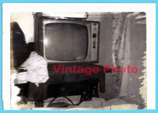 Vintage B&w Polaroid Of Tv Set On Antique Sewing Machine In Messy Room