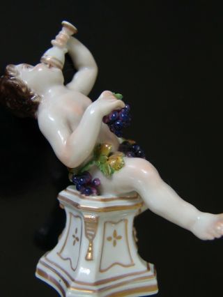 Antique Porcelain Figure Of A Cherub Or Potto Drinking Wine