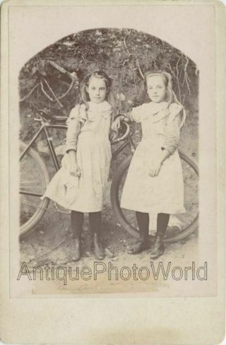 Cute Girls Sisters Posing By Bicycle Antique Cabinet Photo