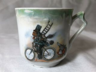 Antique German Child’s Tea Cup – Cat Chimney Sweep On Bicycle With Mole Girl
