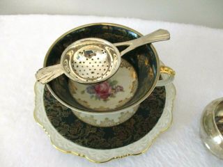 Wunsiedel Bavaria Tea Cup And Saucer Black/gold With Pink Roses,  Tea Strainer