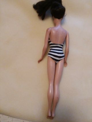 Vintage Barbie in black and white swim suit does have green ears 2