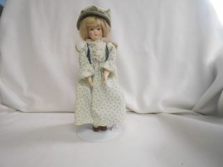 Vintage Porcelain And Cloth Small Doll With Stand Dainty Flower Clothes
