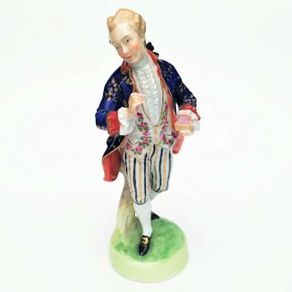 Beautifully Painted Dresden Porcelain Figurine Of A Man Holding A Box