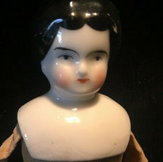 Antique Doll,  7 Inches Tall,  Porcelain Head,  Cloth Body Circa 1870.