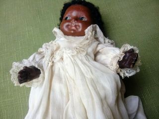 Madame Hedren.  Black Wax Head Child Doll With Old Dress