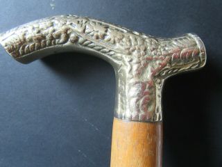 A Brass Handled Wooden Walking Stick.