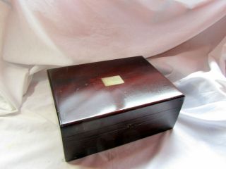 An Antique Wooden Box With Brass Inlay