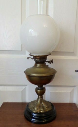 A Victorian Brass Oil Lamp On A Black Glazed Base With White Shade Order