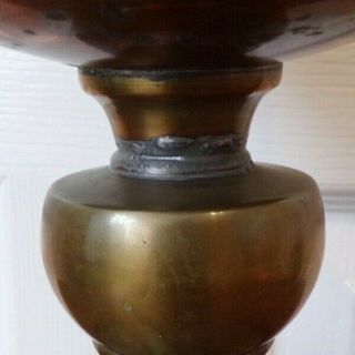 A Victorian brass oil lamp on a black glazed base with White shade order 5