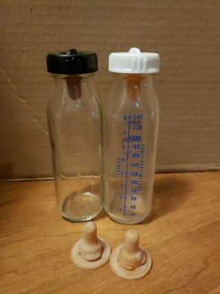 2 Vintage Davol Baby Bottles Glass Antique Feed Rite Colored & Plain W/ Lids