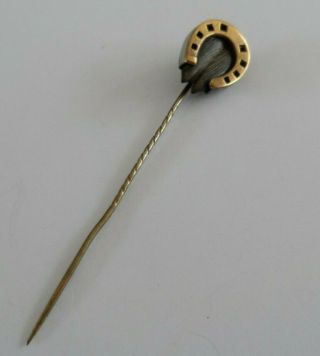 Antique Victorian tie pin in gold toned metal designed as a hoof set horseshoe. 2
