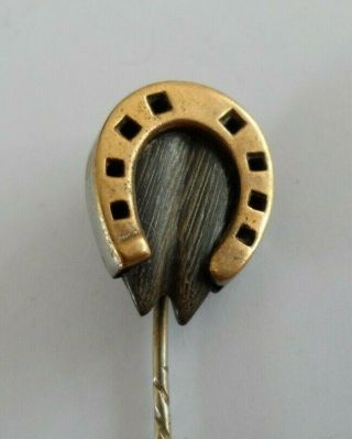 Antique Victorian tie pin in gold toned metal designed as a hoof set horseshoe. 3