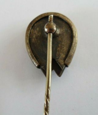 Antique Victorian tie pin in gold toned metal designed as a hoof set horseshoe. 4