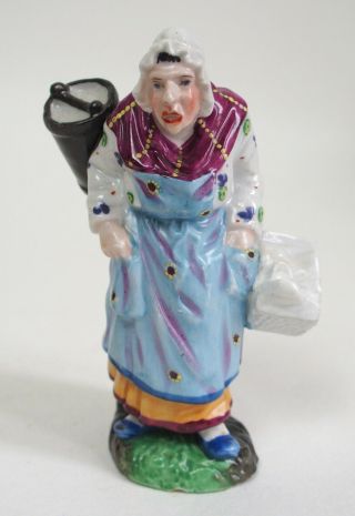 An Antique Continental / French? Porcelain Figure Of A Lady Carrying Baskets