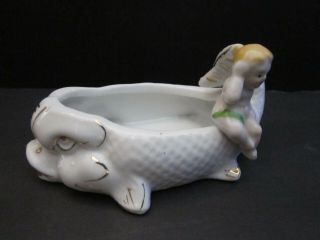 Vintage porcelain baby sitting on a fish dish bowl ashtray mini.  4 1/2 inch. 4