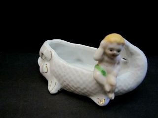 Vintage porcelain baby sitting on a fish dish bowl ashtray mini.  4 1/2 inch. 5