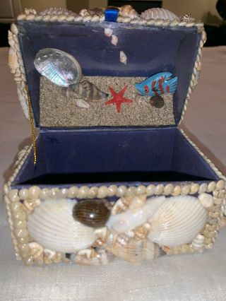 Decorative Boxes With Seashells And Flowers On Them