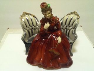 Vintage Ceramic Lady Burgundy Dress Sitting On A Grey Couch Figurine