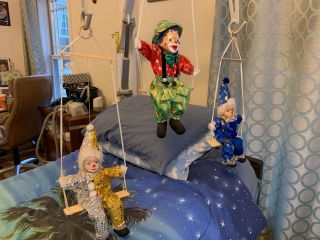 Set Of Porcelain Clowns Hanging On A Swing