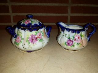 Antique Hand Painted Sugar Bowl And Creamer With Gold Guilding.