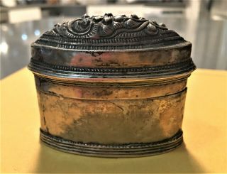 Oval two piece Thai metal box with decorated top and Thai inscriptions on bottom 3