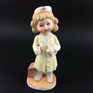 Vintage Nurse Blonde Little Girl Bisque Porcelain Figurine Yellow Outfit 4 1/2 "