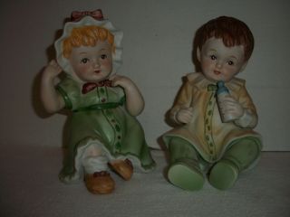 Set Of 2 Vintage Flambro Porcelain Bisque Boy & Girl Piano Baby Figurines