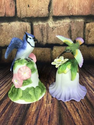 Set Of Two Porcelain Bells Blue Jay And Hummingbird Avon Collectibles 4.  25 " Tall