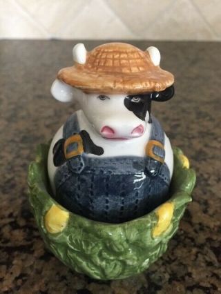 Vinatge Clay Art Cow Farmer Sitting In A Cornfield Salt And Pepper Shaker Set