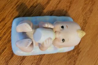 Vintage Bisque Baby Boy With Bottle On A Blue Blanket Figurine.  Made In Korea.